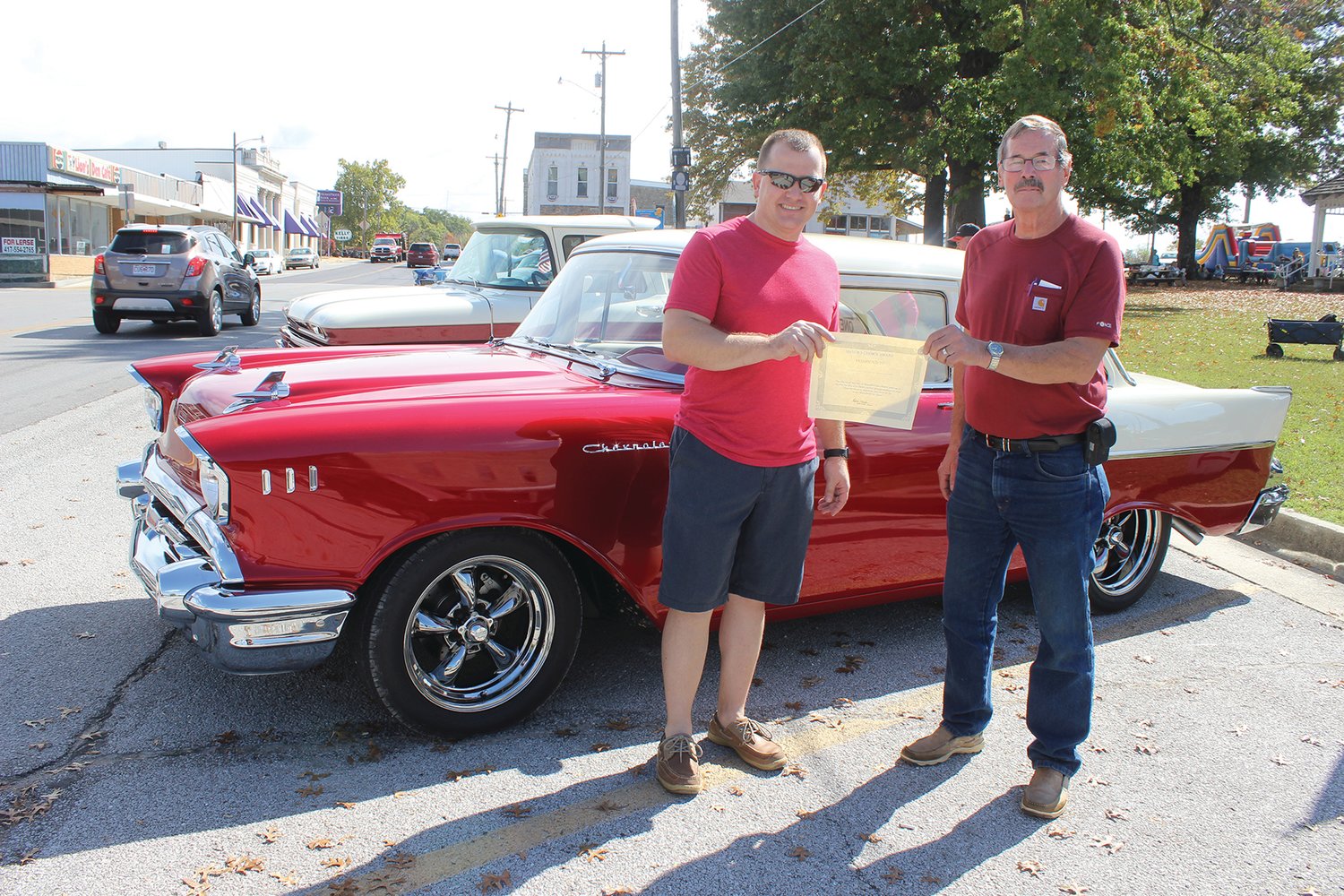 City of Mansfield Mayor Blake Miller presents the Mayor’s Choice Award to Gary Corder in front of Corder’s 1957 Chevy.